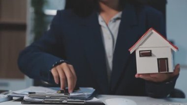 Emlakçıyla el ele tutuşan kadın modeli..