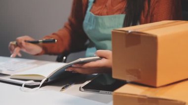 Kadın eli, müşteriye bir paket kutusu tutuyor.