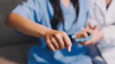 Hastanede steteskop kullanan üniformalı genç bir bayan doktor.