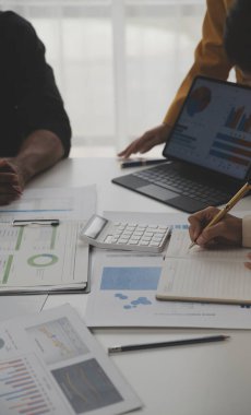 Close up of Business team analyzing income charts and graphs with modern laptop computer. Business analysis and strategy concept.