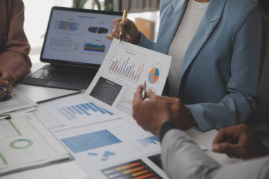 Close up of Business team analyzing income charts and graphs with modern laptop computer. Business analysis and strategy concept.