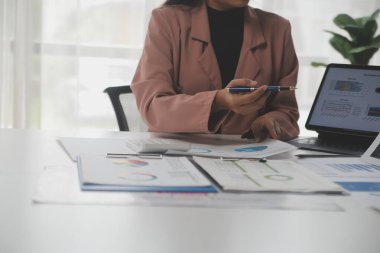 Close up of Business team analyzing income charts and graphs with modern laptop computer. Business analysis and strategy concept.