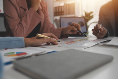 Close up of Business team analyzing income charts and graphs with modern laptop computer. Business analysis and strategy concept.