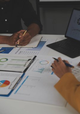 Close up of Business team analyzing income charts and graphs with modern laptop computer. Business analysis and strategy concept.
