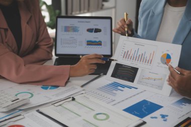 Close up of Business team analyzing income charts and graphs with modern laptop computer. Business analysis and strategy concept.