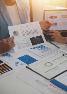 Close up of Business team analyzing income charts and graphs with modern laptop computer. Business analysis and strategy concept.