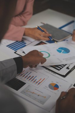 Close up of Business team analyzing income charts and graphs with modern laptop computer. Business analysis and strategy concept.