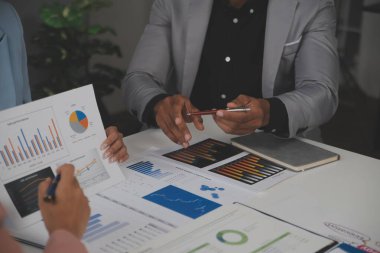 Close up of Business team analyzing income charts and graphs with modern laptop computer. Business analysis and strategy concept.