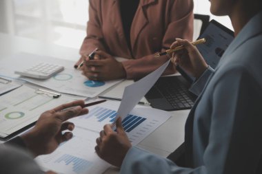 Close up of Business team analyzing income charts and graphs with modern laptop computer. Business analysis and strategy concept.