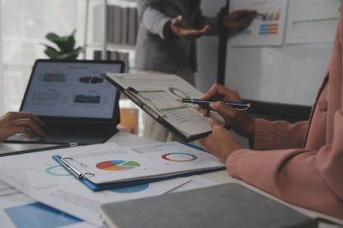 Modern dizüstü bilgisayarla gelir tabloları ve grafiklerini analiz eden iş ekibini kapatın. İş analizi ve strateji kavramı.