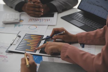 Close up of Business team analyzing income charts and graphs with modern laptop computer. Business analysis and strategy concept.