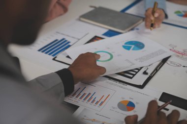 Close up of Business team analyzing income charts and graphs with modern laptop computer. Business analysis and strategy concept.