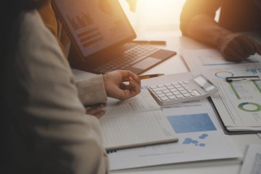 Close up of Business team analyzing income charts and graphs with modern laptop computer. Business analysis and strategy concept.