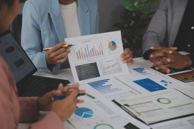 Modern dizüstü bilgisayarla gelir tabloları ve grafiklerini analiz eden iş ekibini kapatın. İş analizi ve strateji kavramı.