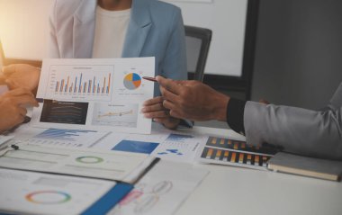Close up of Business team analyzing income charts and graphs with modern laptop computer. Business analysis and strategy concept.