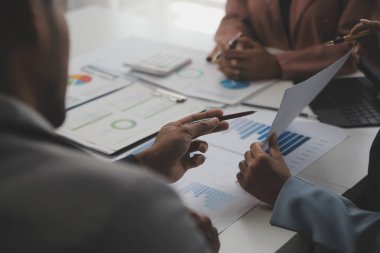 Close up of Business team analyzing income charts and graphs with modern laptop computer. Business analysis and strategy concept.