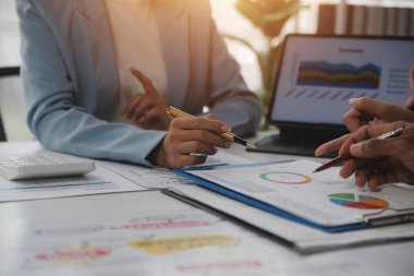 Close up of Business team analyzing income charts and graphs with modern laptop computer. Business analysis and strategy concept.