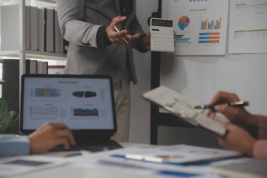 Close up of Business team analyzing income charts and graphs with modern laptop computer. Business analysis and strategy concept.