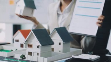 İş adamı model ev modeli ve emlakçı tutuyor. emlak sigortası