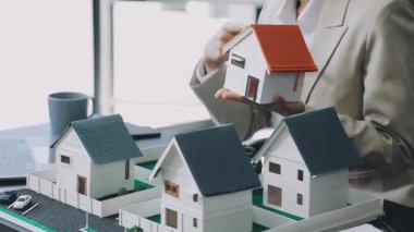 Masada minyatür ev modelini tutan kadın..