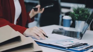 İş kadını ofiste kağıda yazı yazıyor.