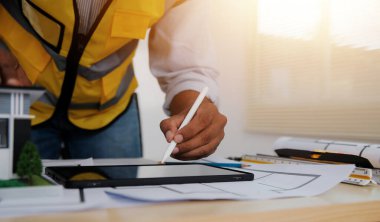 Mimari proje için mühendis toplantısı. İş yeri vintage tonu üzerinde ortak ve mühendislik araçları ile çalışmak.