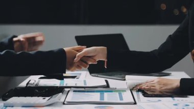 Ekonomik tablolar ve grafikleri tartışan ve tartışan iş ekibi