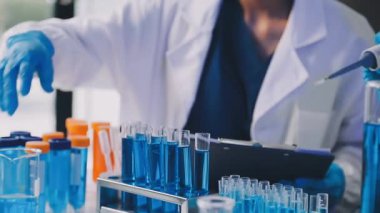 Kadın bilim adamı bir kimya laboratuvarında çalışıyor.