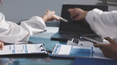 Modern ofiste tablet ve dizüstü bilgisayarla çalışan genç kadın doktoru kapatın..