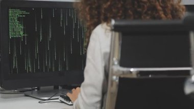 İş kadını karanlık bir odada bilgisayar klavyesinde daktilo kullanıyor.