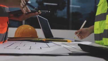 Mühendis inşaat odasında proje üzerinde çalışıyor..