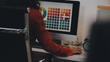 Stüdyoda dizüstü bilgisayarda çalışan tasarımcı