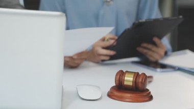 Avukat, hukukçu, avukat ya da hâkim resepsiyonda yasal belgelerle çalışıyor.