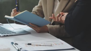 İş kadını elinde kalem ve defter tutuyor.