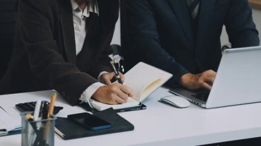 İş adamları birlikte çalışır ve bilgisayarlar ofiste çalışır..