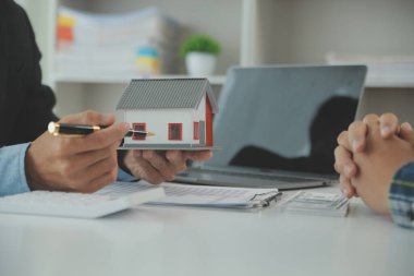 Emlakçı ve müşteri ev, sigorta ya da emlak satın almak için sözleşme imzalarlar. Ev kiralarlar, sigorta yaptırırlar, emlak veya emlak kredisi alırlar..