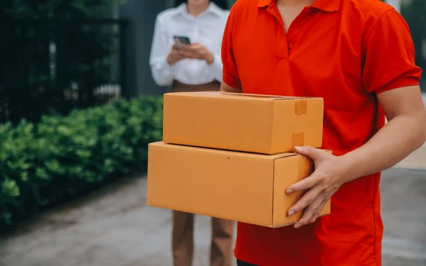 Asian Woman Receiving Product from delivery man at Home, Young Owner Woman Order Product from Smartphone Application, Woman with Online Business or SME Concept.