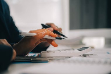 Finansal analistler, şirketlerin başarılı takım çalışmalarının sonuçlarını gösteren bir toplantıda bir dijital tablet planlama yatırım projesinin ticari mali raporlarını analiz ediyorlar..