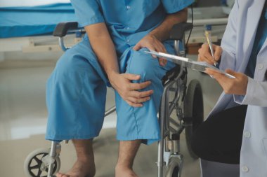 young asian physical therapist working with senior woman on walking with a walker