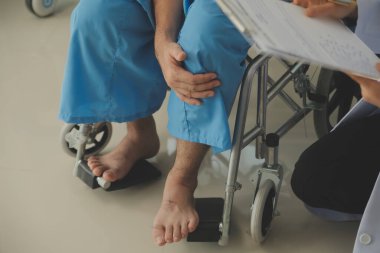 young asian physical therapist working with senior woman on walking with a walker