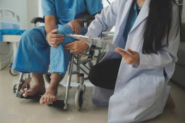 young asian physical therapist working with senior woman on walking with a walker