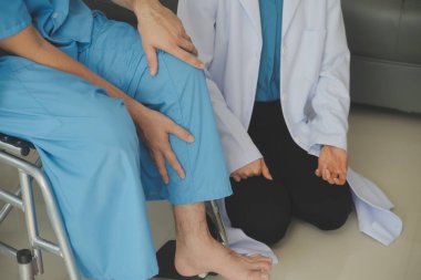 young asian physical therapist working with senior woman on walking with a walker