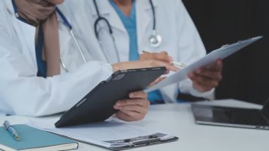 Kadın doktor elinde kalemle deftere bir şeyler yazıyor. tıbbi geçmiş