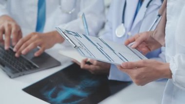 Doktor ve tıbbi ekip klinikte tablet sonuçlarını tartışıyor