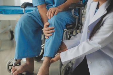 young asian physical therapist working with senior woman on walking with a walker