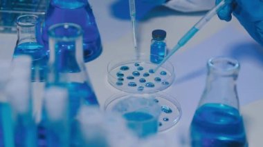 Laboratuvarda mavi renkli sıvı bulunan bir laboratuvar camı.