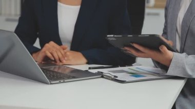 Ofiste iş kadınlarının el ele tutuştuğu tablet bilgisayarı kapat