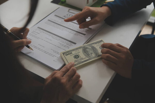 Business Signing a Contract Buy - sell house, insurance agent analyzing about home investment loan Real Estate concept.
