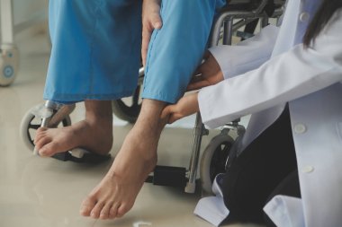 young asian physical therapist working with senior woman on walking with a walker