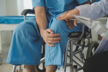 young asian physical therapist working with senior woman on walking with a walker